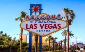sign saying welcome tofabulous las vegas nevada with palm trees behind the sign
