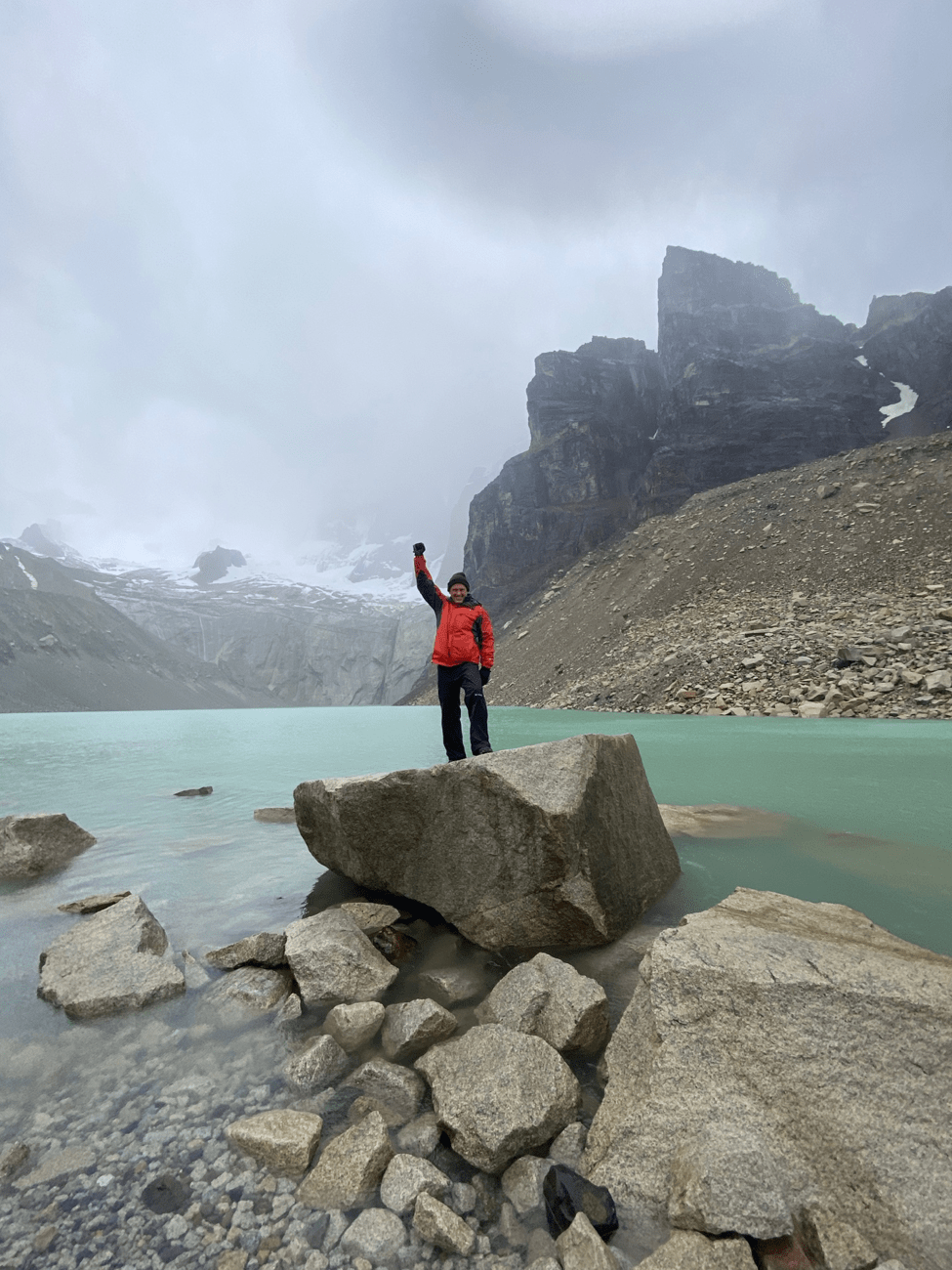 Lonny standing in hiking gear at Torres del Paine on a cloudy day