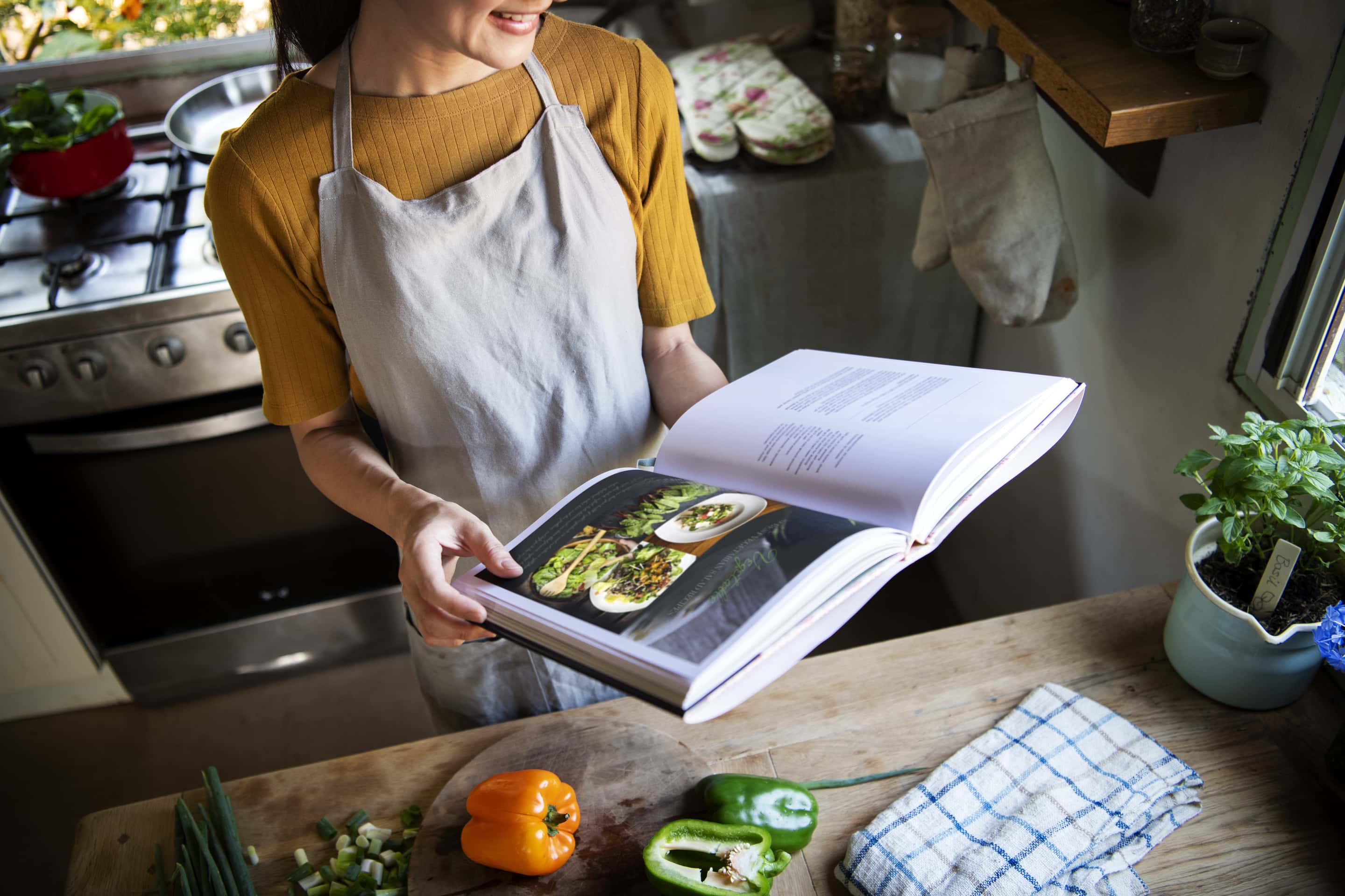 woman reading through recipe book for low card diets