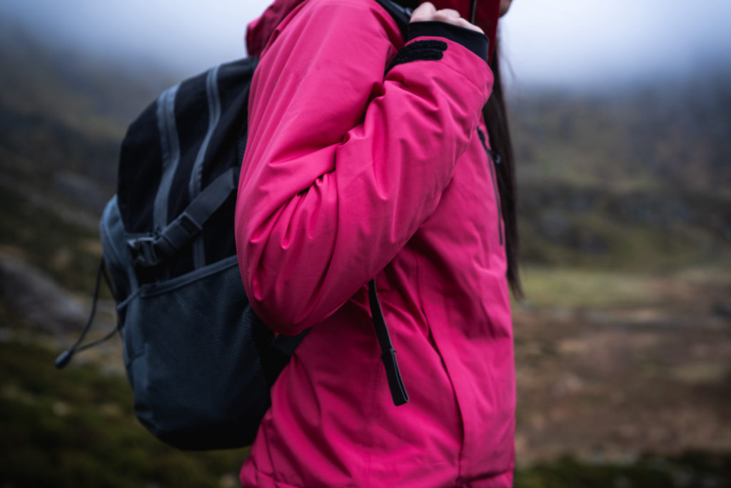 woman wears nice light jacket on a hike